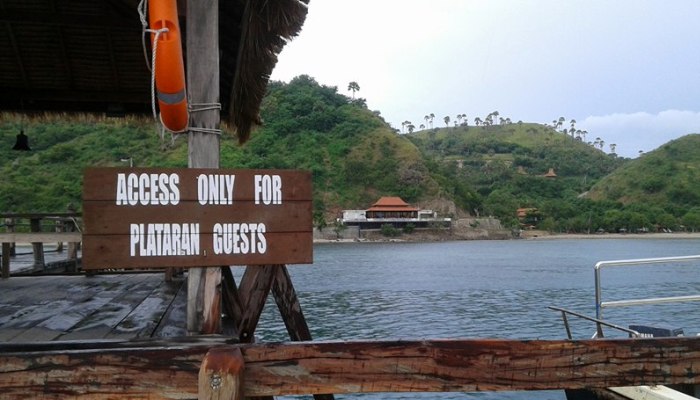 Warga disambut tulisan ini saat tiba di dermaga menuju Restoran Atlantis dan Hotel Pelataran. (Foto: Ferdinand Ambo/Floresa)